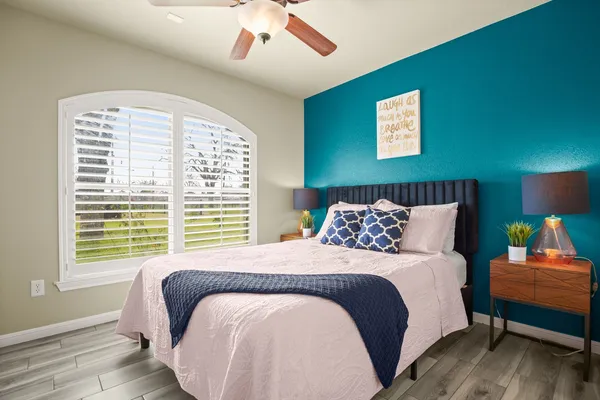 a bedroom with a bed and wooden floor