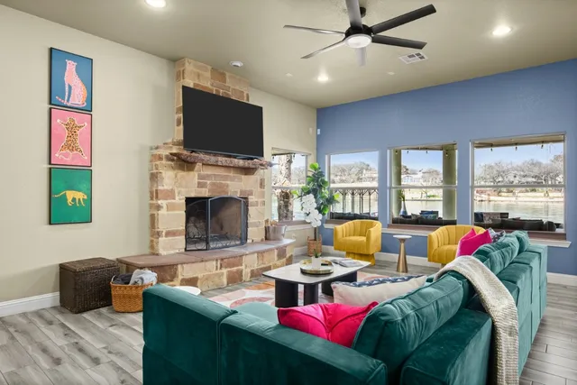a living room with fireplace furniture and a flat screen tv