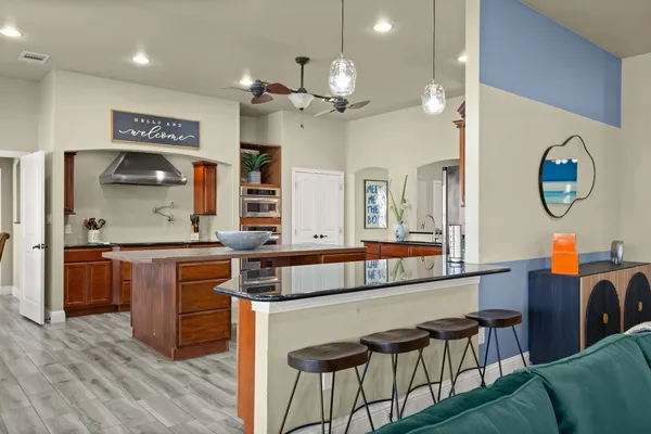 a living room with granite countertop furniture and kitchen view