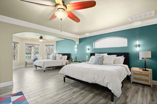 a bedroom with a bed and a chandelier