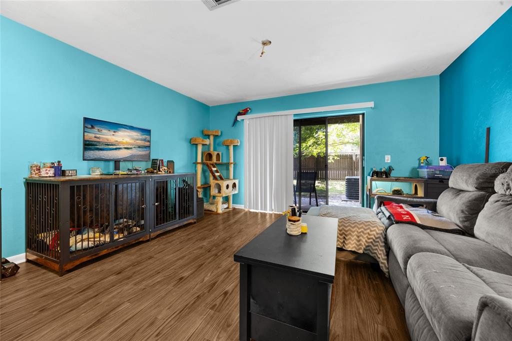 2735 Southwest 35th Place, Unit 306 Gainesville, FL 32608 - Photo 13 of 23 a living room with furniture and a flat screen tv