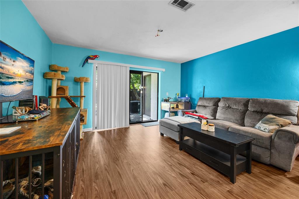 2735 Southwest 35th Place, Unit 306 Gainesville, FL 32608 - Photo 14 of 23 a living room with furniture and a flat screen tv