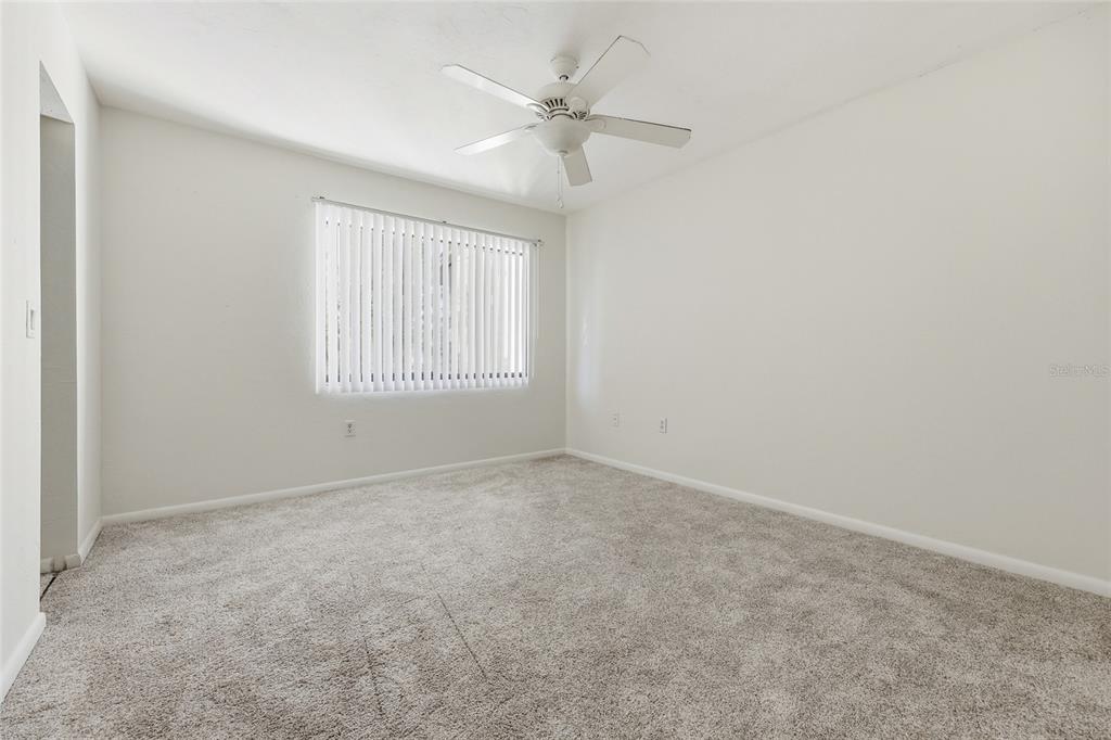 2735 Southwest 35th Place, Unit 306 Gainesville, FL 32608 - Photo 14 of 17 an empty room with a ceiling fan and window