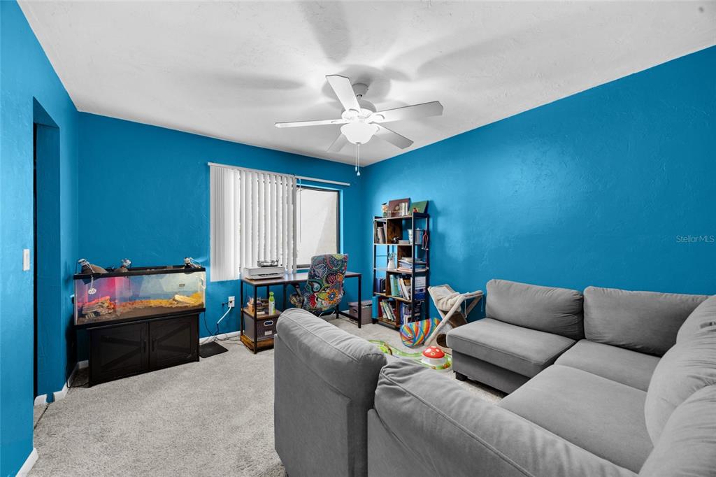 2735 Southwest 35th Place, Unit 306 Gainesville, FL 32608 - Photo 16 of 23 a living room with furniture and a window