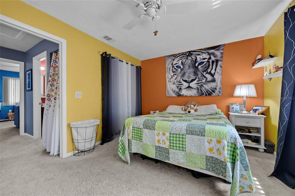 2735 Southwest 35th Place, Unit 306 Gainesville, FL 32608 - Photo 18 of 23 a bedroom with a bed and a chandelier