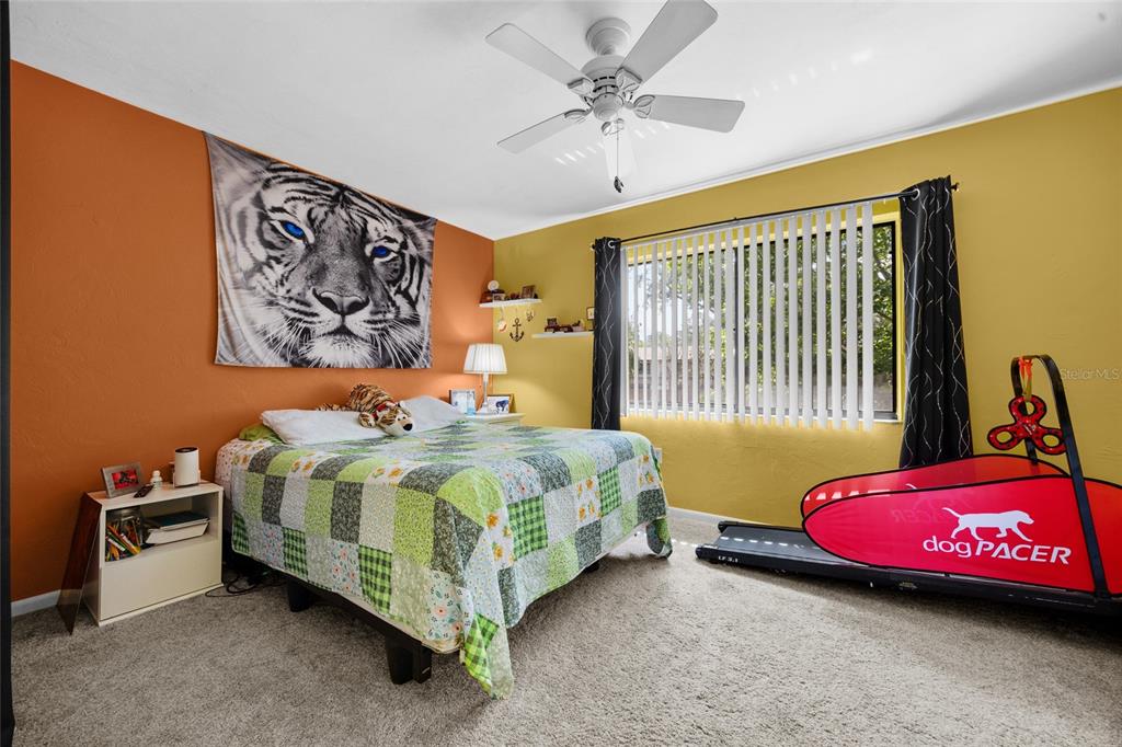 2735 Southwest 35th Place, Unit 306 Gainesville, FL 32608 - Photo 19 of 23 a bedroom with a bed and a chandelier