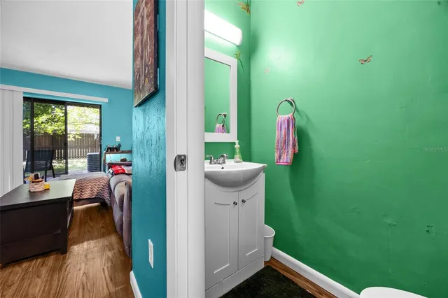 a view of a room that has a bed and a bookshelf