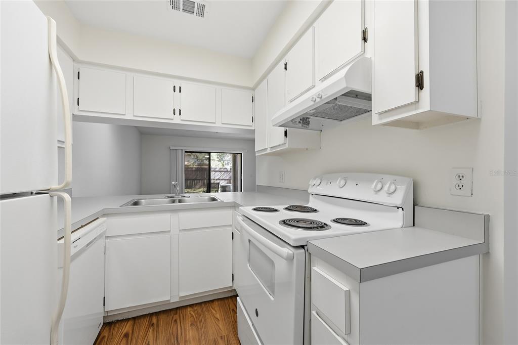2735 Southwest 35th Place, Unit 306 Gainesville, FL 32608 - Photo 3 of 17 a kitchen with appliances cabinets and a sink