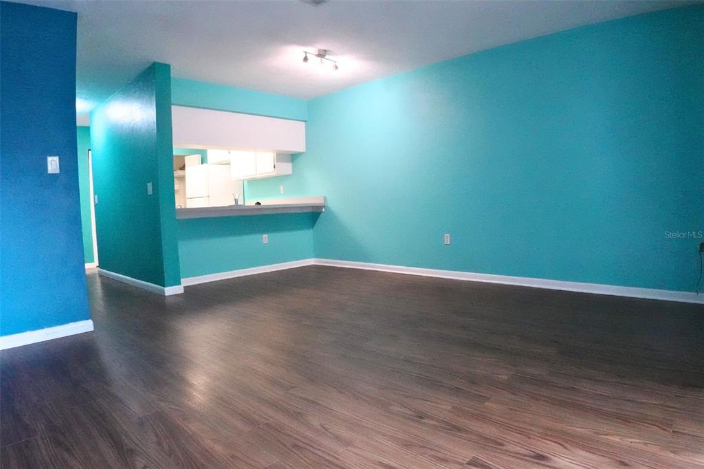 2735 Southwest 35th Place, Unit 306 Gainesville, FL 32608 - Photo 5 of 23 an empty room with wooden floor and windows