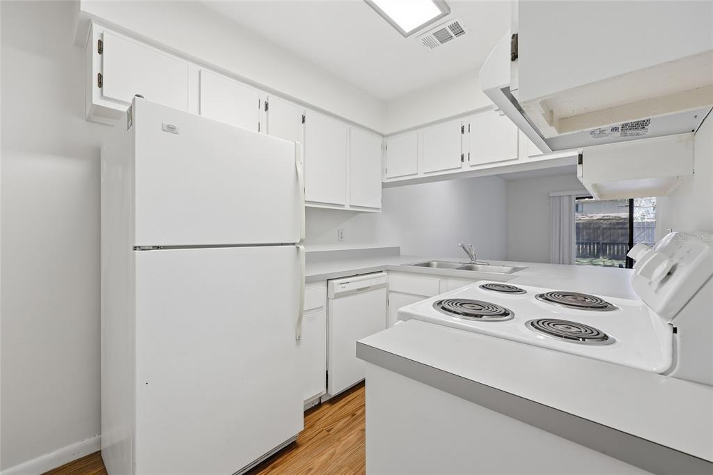 2735 Southwest 35th Place, Unit 306 Gainesville, FL 32608 - Photo 5 of 17 a white refrigerator freezer and a stove