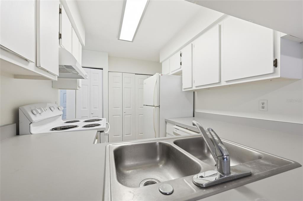 2735 Southwest 35th Place, Unit 306 Gainesville, FL 32608 - Photo 6 of 17 a kitchen with appliances a sink and cabinets