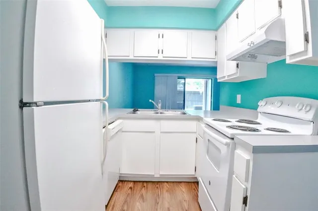 a kitchen with a sink and a refrigerator
