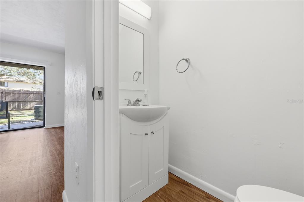 2735 Southwest 35th Place, Unit 306 Gainesville, FL 32608 - Photo 7 of 17 a bathroom with a sink mirror and toilet
