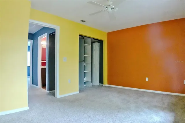 a view of a room with a projector and a ceiling fan