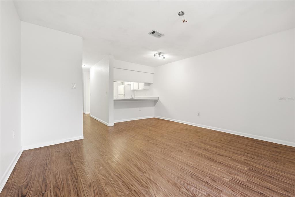2735 Southwest 35th Place, Unit 306 Gainesville, FL 32608 - Photo 10 of 17 an empty room with wooden floor and windows
