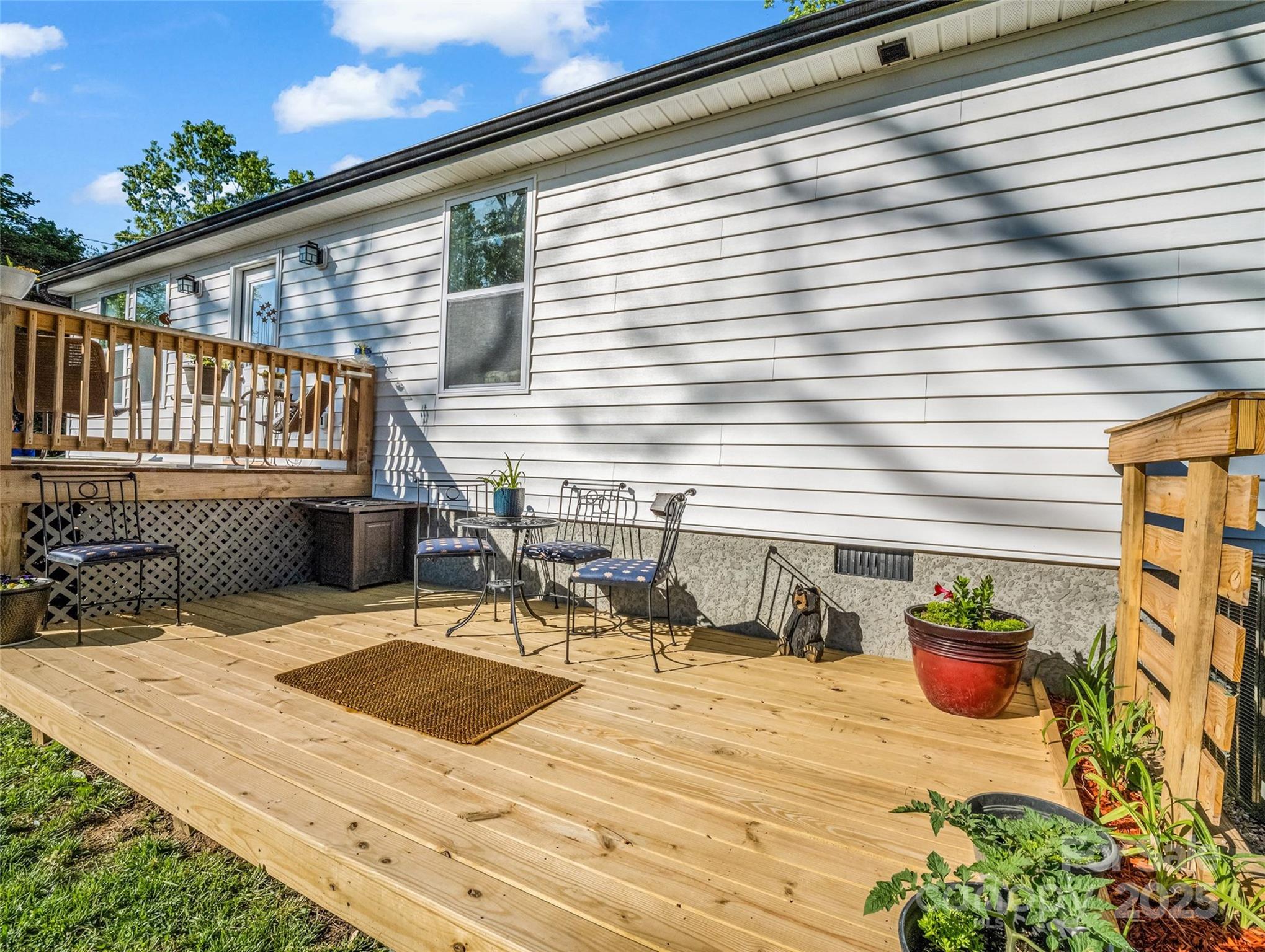 566 Blue Ridge Road Black Mountain, NC 28711 - Photo 13 of 41 a view of a balcony with chairs and potted plants