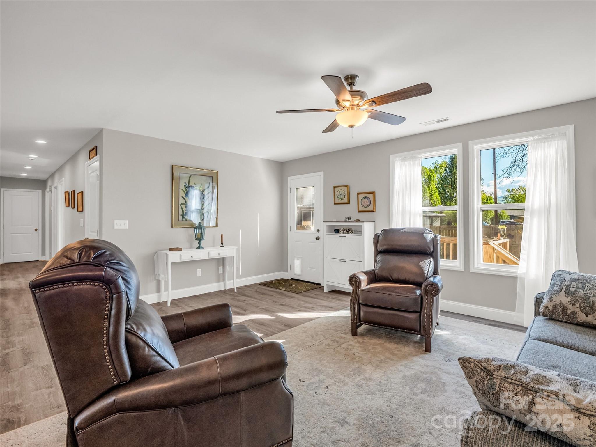 566 Blue Ridge Road Black Mountain, NC 28711 - Photo 19 of 41 a living room with furniture ceiling fan and a window