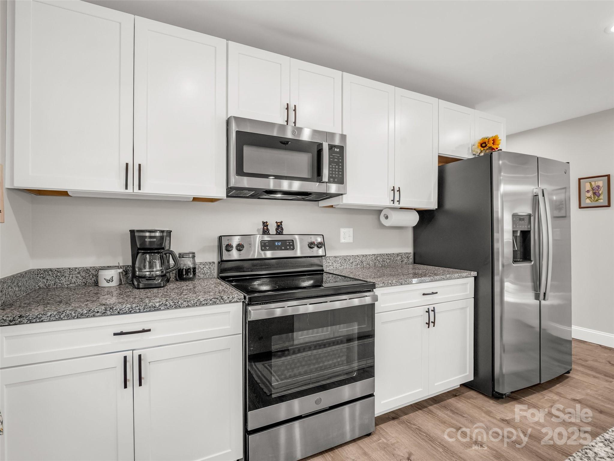566 Blue Ridge Road Black Mountain, NC 28711 - Photo 27 of 41 a kitchen with stainless steel appliances granite countertop a stove a refrigerator and a sink
