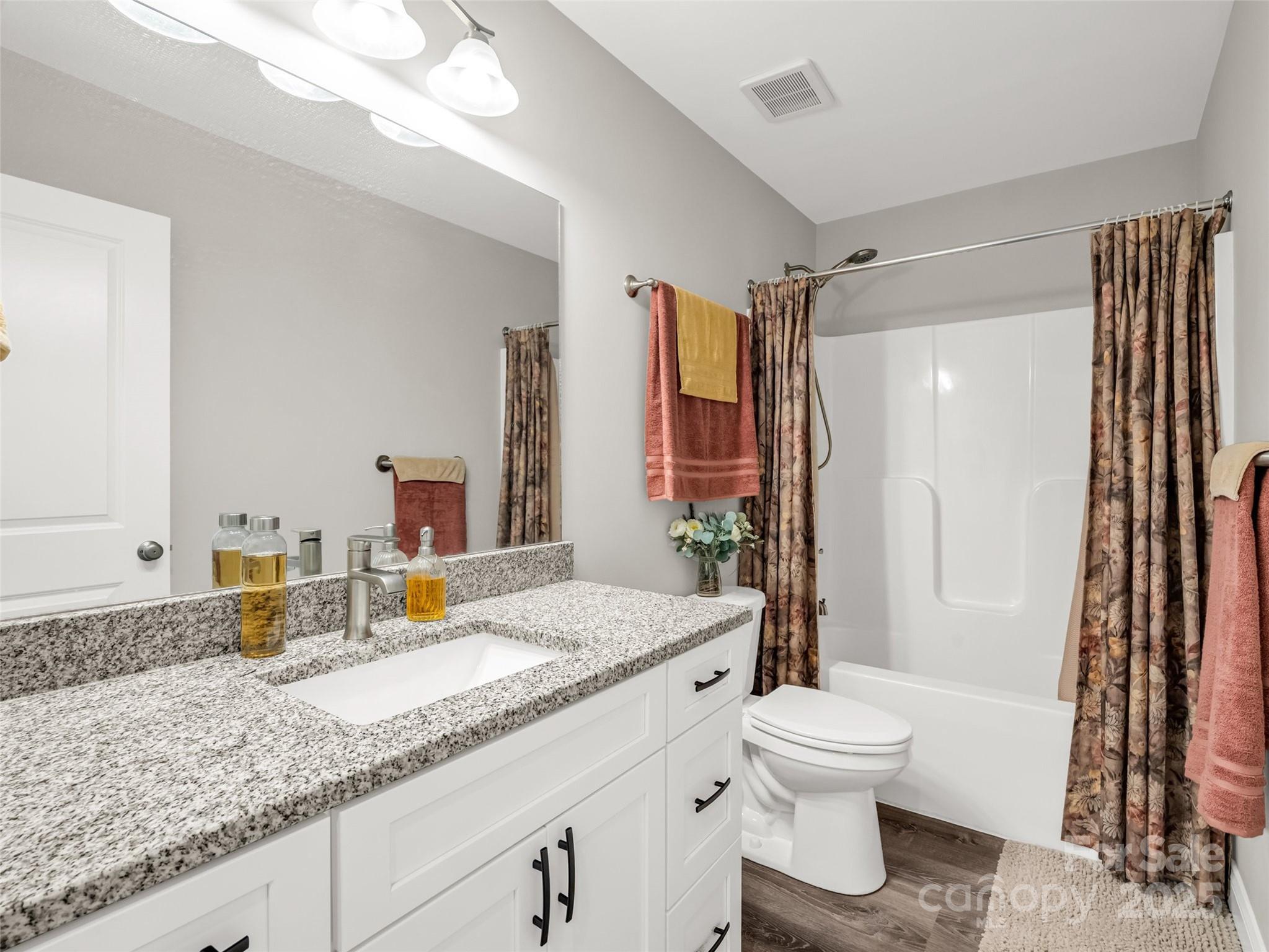 566 Blue Ridge Road Black Mountain, NC 28711 - Photo 30 of 41 a bathroom with a granite countertop sink toilet and shower