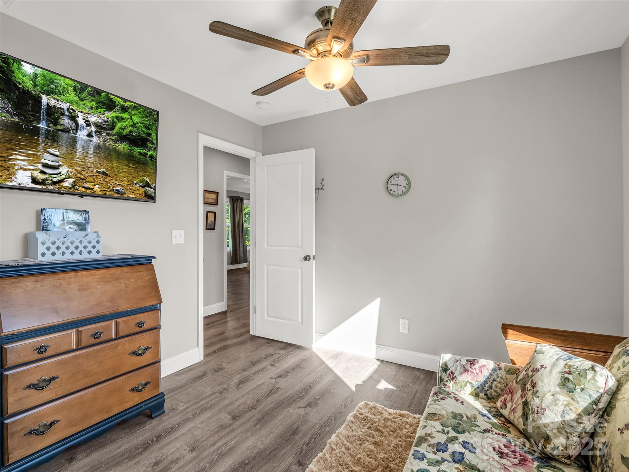566 Blue Ridge Road Black Mountain, NC 28711 - Photo 34 of 41 a bedroom with a bed and a dresser in it