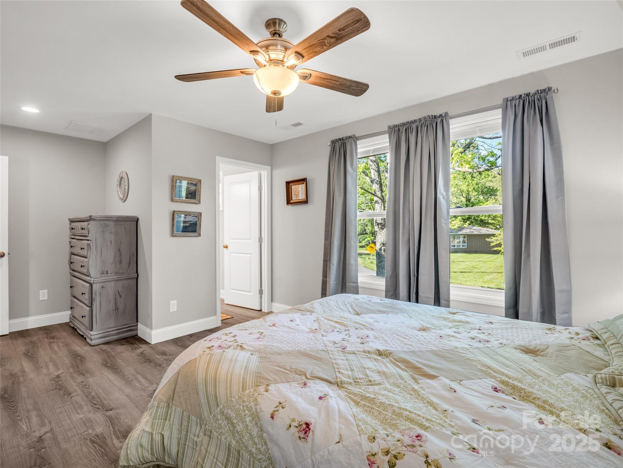 566 Blue Ridge Road Black Mountain, NC 28711 - Photo 36 of 41 a bedroom with a large bed and a window