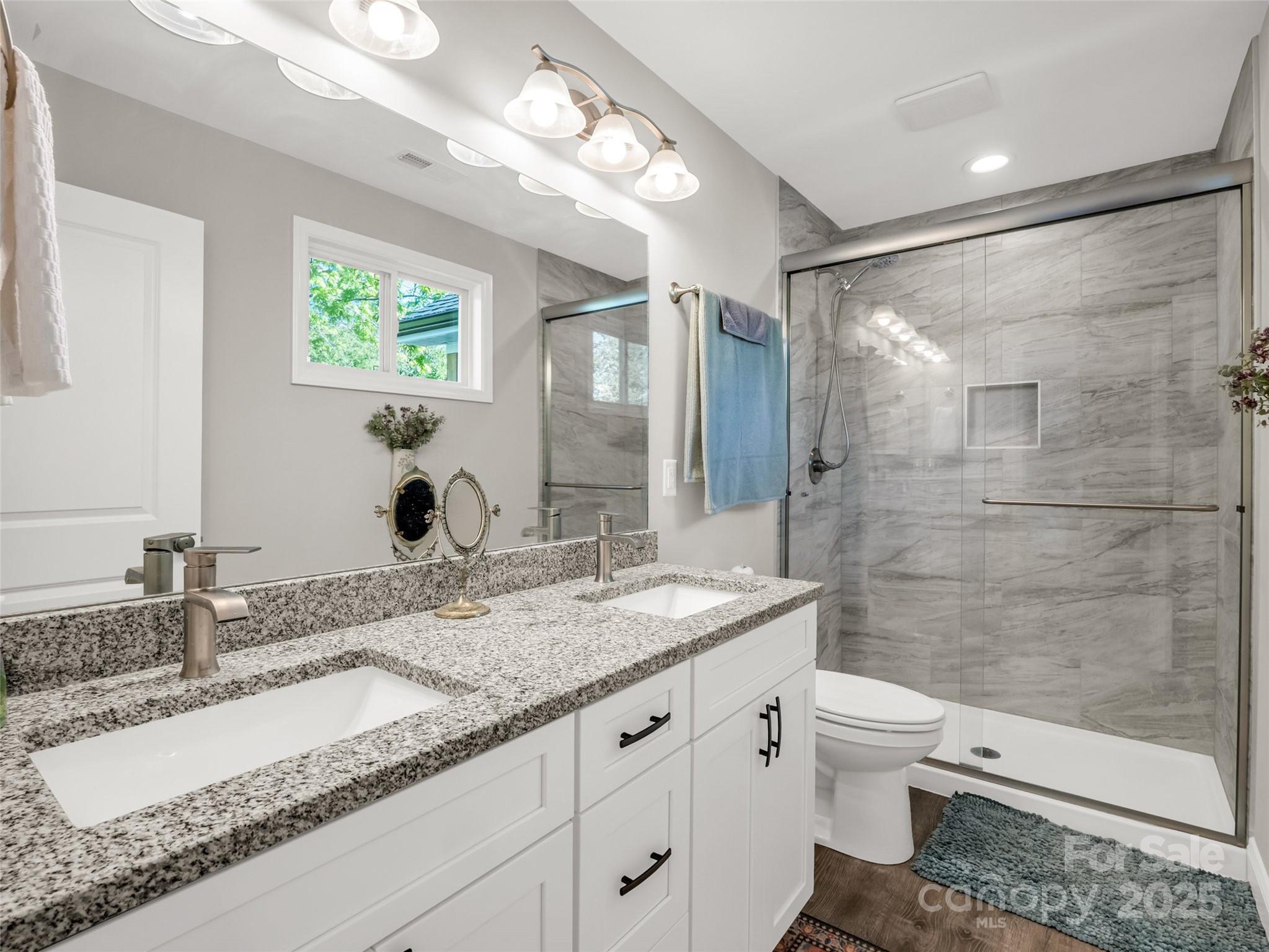566 Blue Ridge Road Black Mountain, NC 28711 - Photo 38 of 41 a bathroom with a granite countertop sink toilet and shower