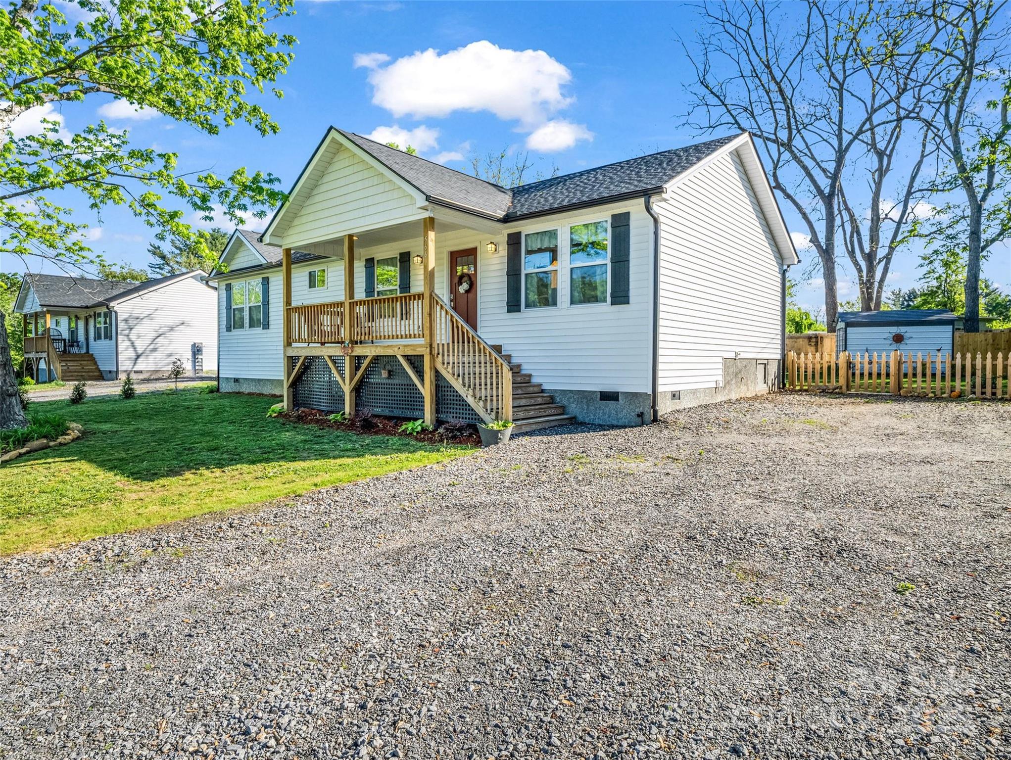 566 Blue Ridge Road Black Mountain, NC 28711 - Photo 5 of 41 a view of a house with backyard and a tree