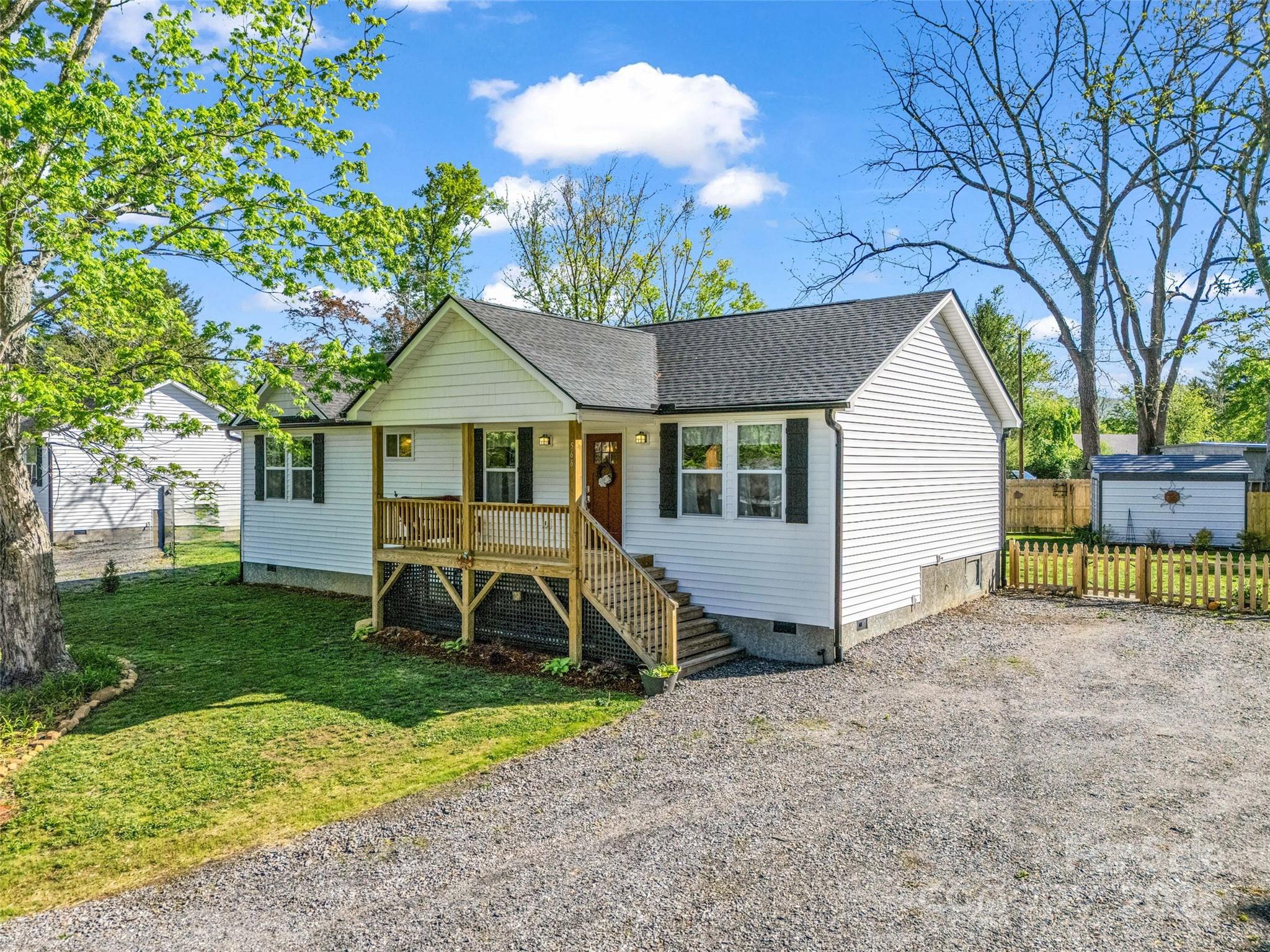 566 Blue Ridge Road Black Mountain, NC 28711 - Photo 6 of 41 a view of a house with backyard and a tree