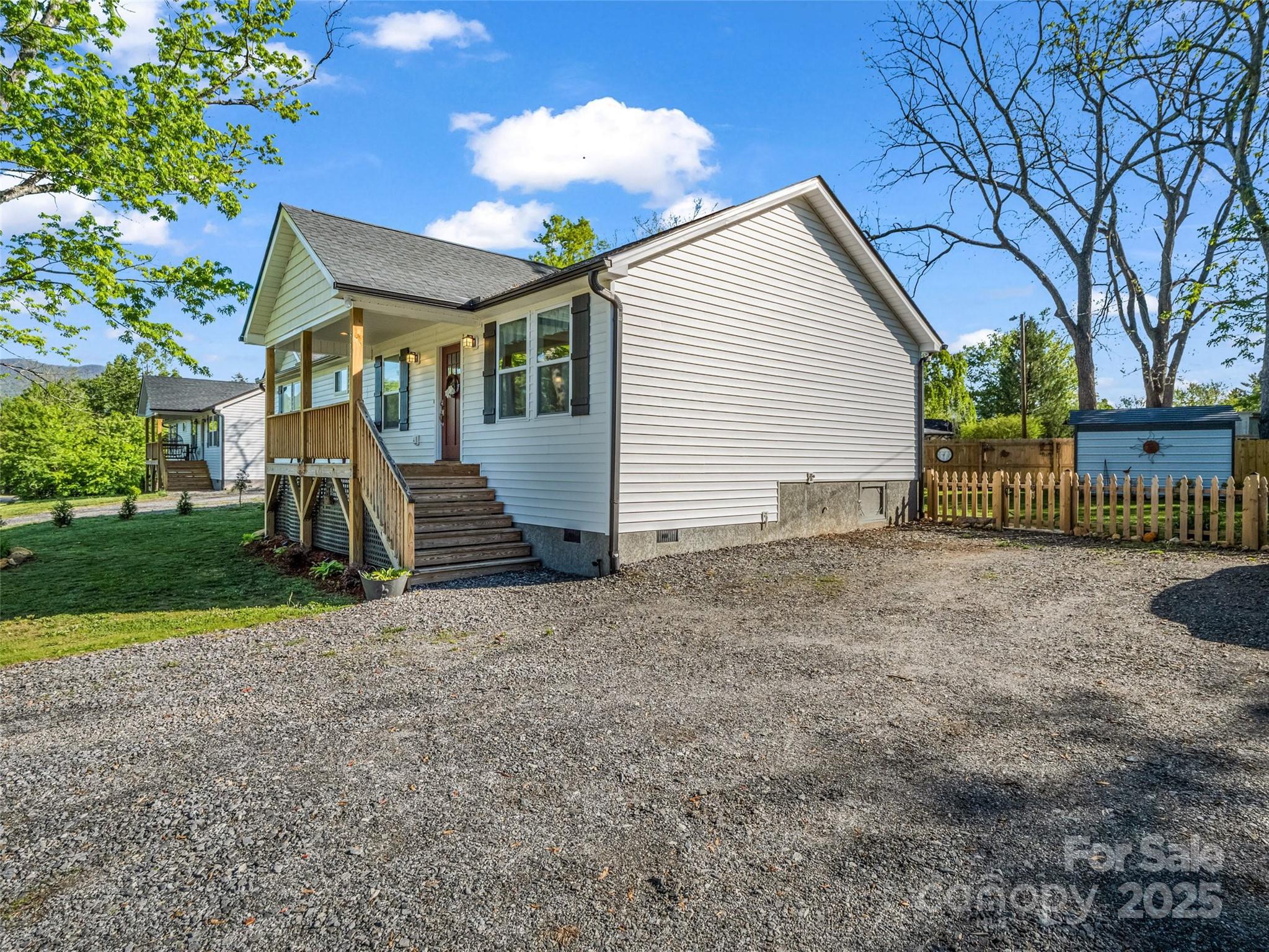 566 Blue Ridge Road Black Mountain, NC 28711 - Photo 7 of 41 a view of a house with a yard and garage