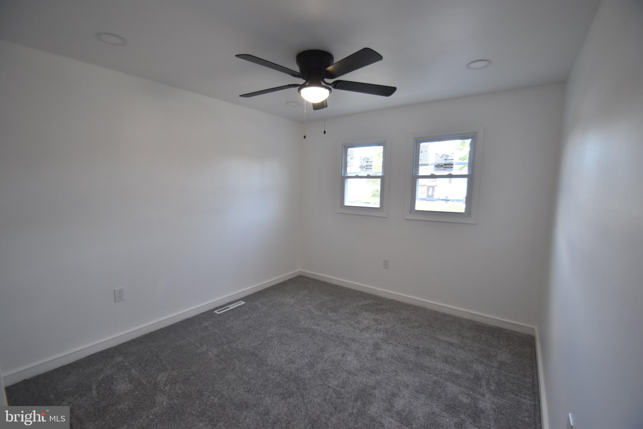 6 Russell Road New Castle, DE 19720 - Photo 13 of 16 an empty room with windows and ceiling fan view