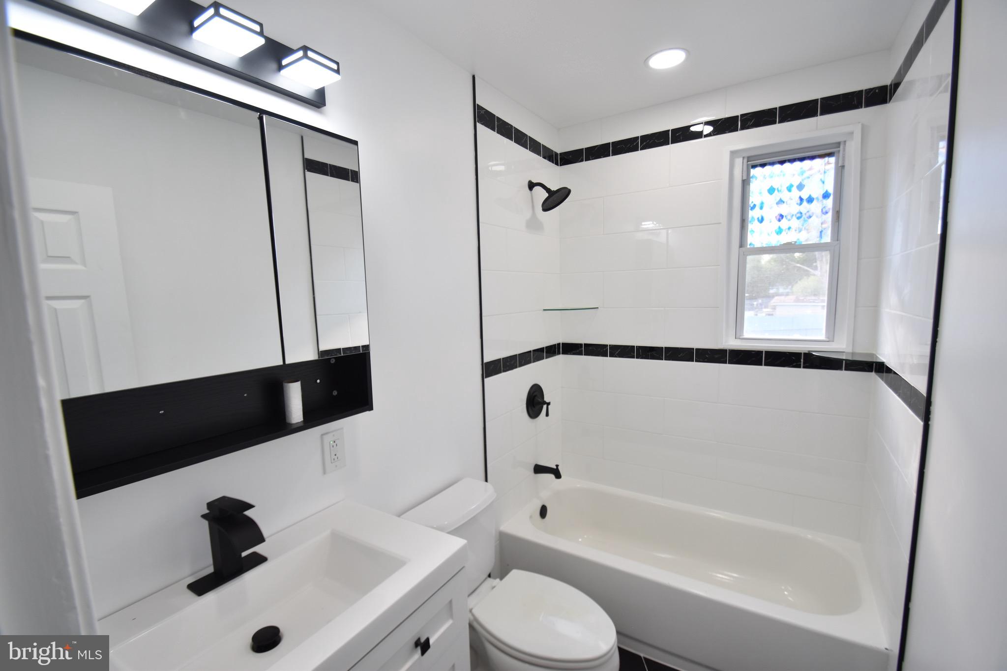 6 Russell Road New Castle, DE 19720 - Photo 14 of 16 a bathroom with a bathtub shower sink vanity and toilet