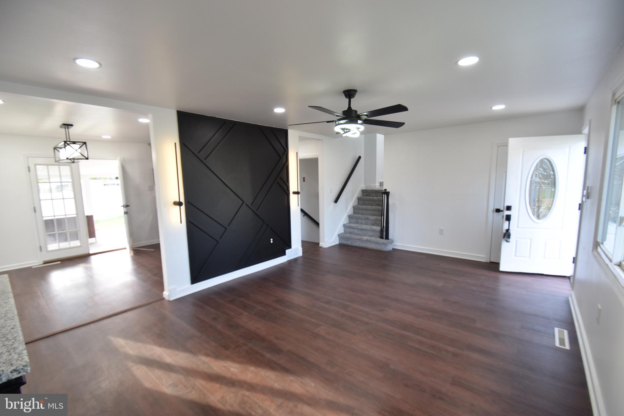 6 Russell Road New Castle, DE 19720 - Photo 2 of 16 an empty room with wooden floor and windows