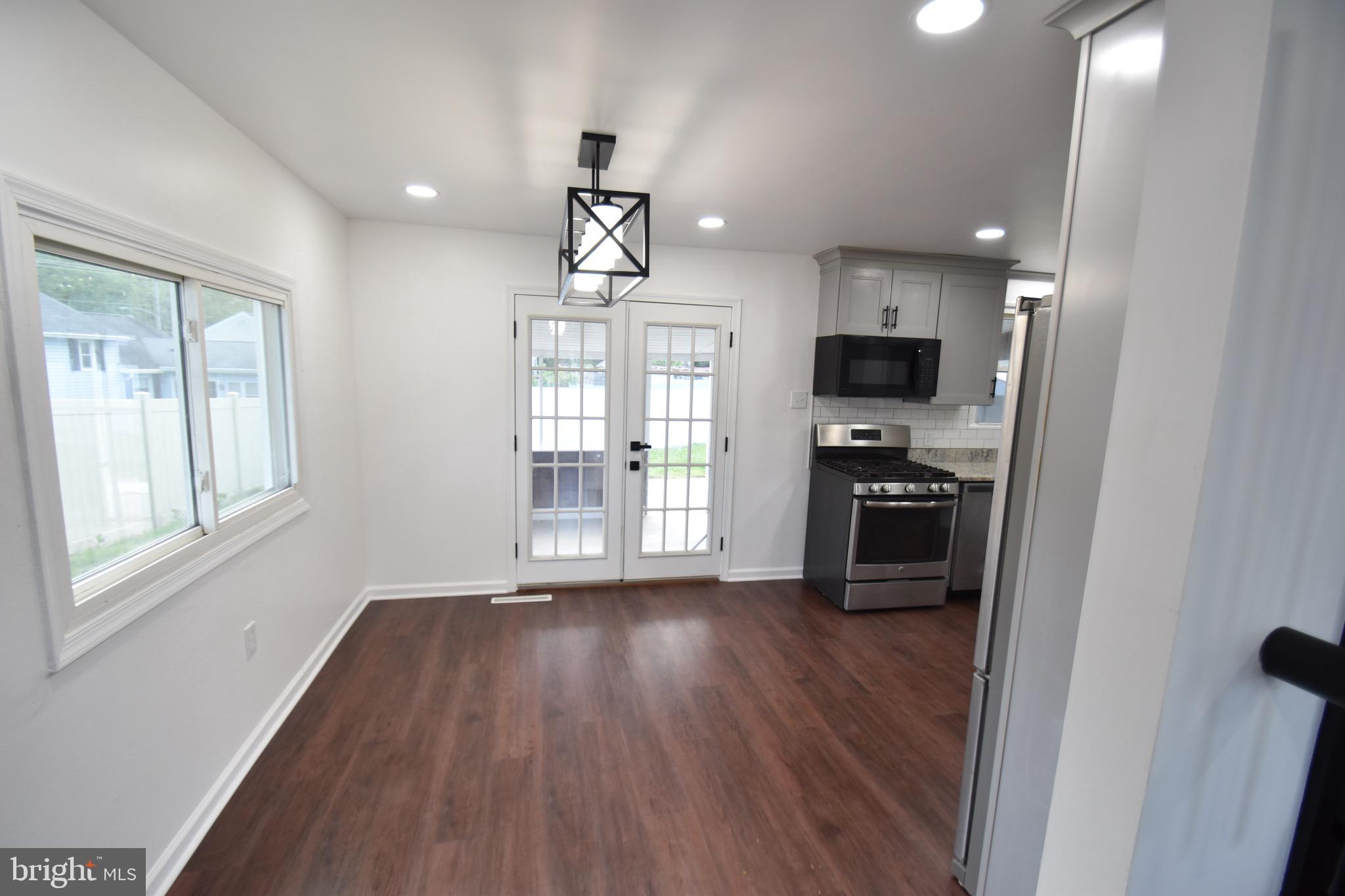 6 Russell Road New Castle, DE 19720 - Photo 5 of 16 a kitchen with sink a refrigerator and wooden floor
