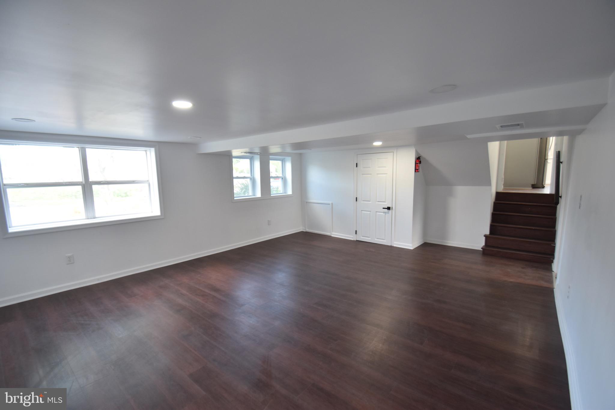 6 Russell Road New Castle, DE 19720 - Photo 7 of 16 an empty room with wooden floor and windows