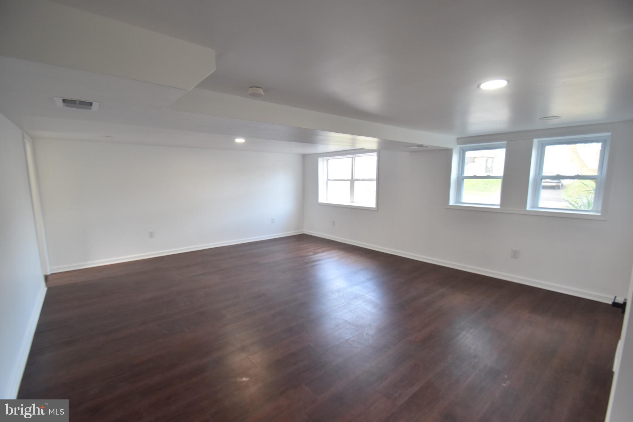 6 Russell Road New Castle, DE 19720 - Photo 8 of 16 an empty room with wooden floor and windows