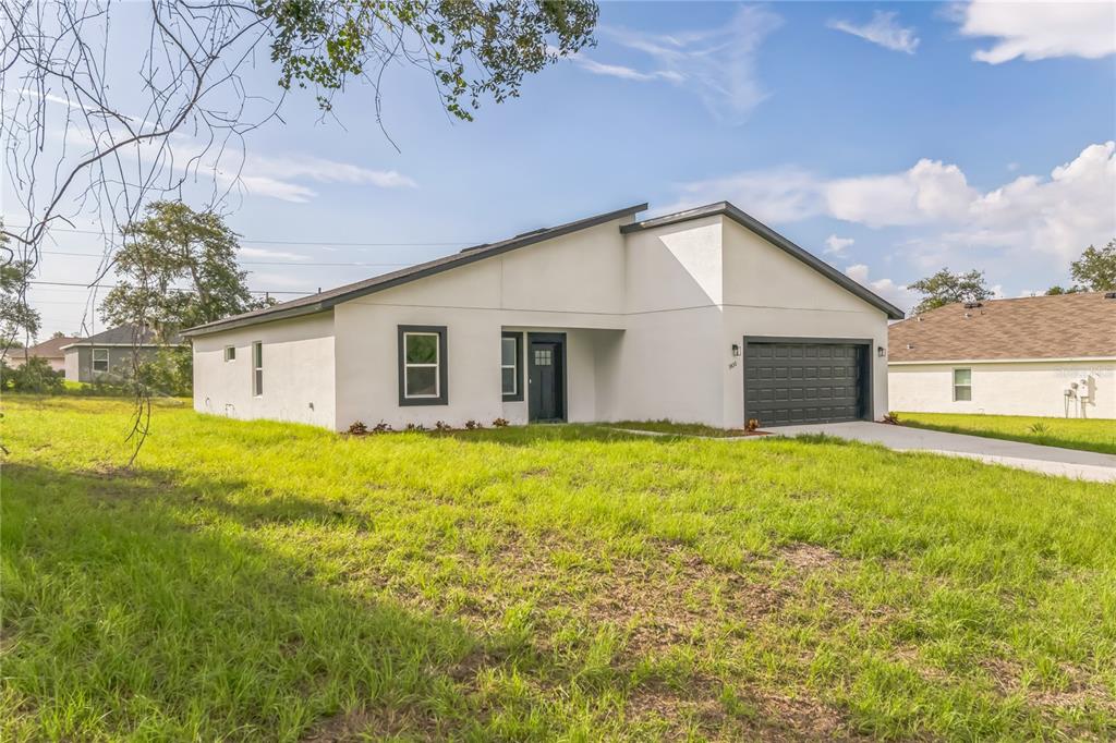 8151 Southwest 135th Loop Ocala, FL 34473 - Photo 1 of 1 a view of a backyard with plants and large tree