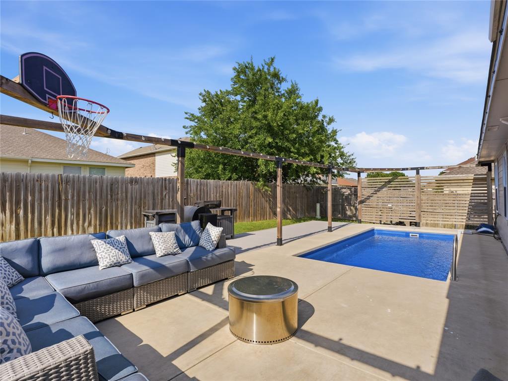12724 Carpenter Lane Rhome, TX 76078 - Photo 25 of 37 Backyard featuring a privacy fence, concrete patio, and in-ground pool