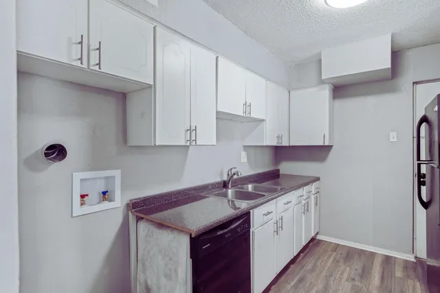 a kitchen with stainless steel appliances granite countertop a sink stove and cabinets