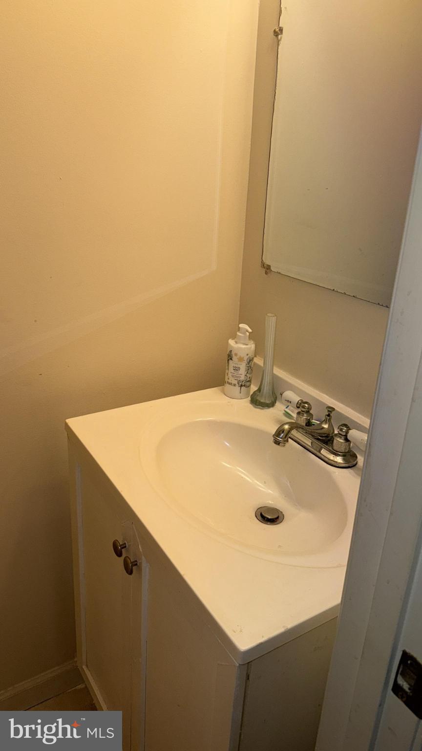 2586 West Fayette Street Baltimore, MD 21223 - Photo 13 of 17 a bathroom with a sink and a mirror