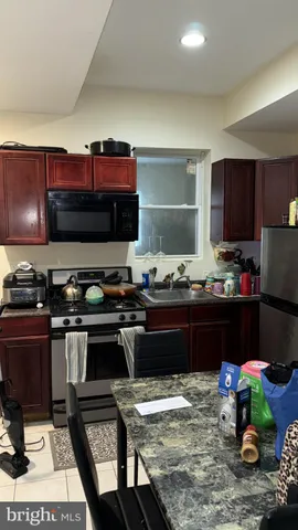 a kitchen with a stove and a refrigerator