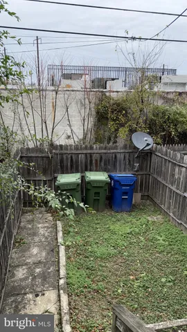 a view of a chair and table in backyard