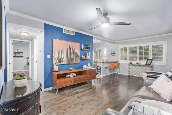 a living room with furniture and wooden floor