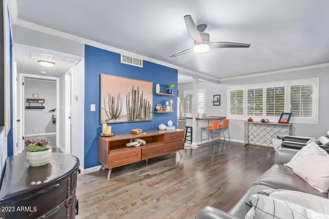 a living room with furniture and wooden floor
