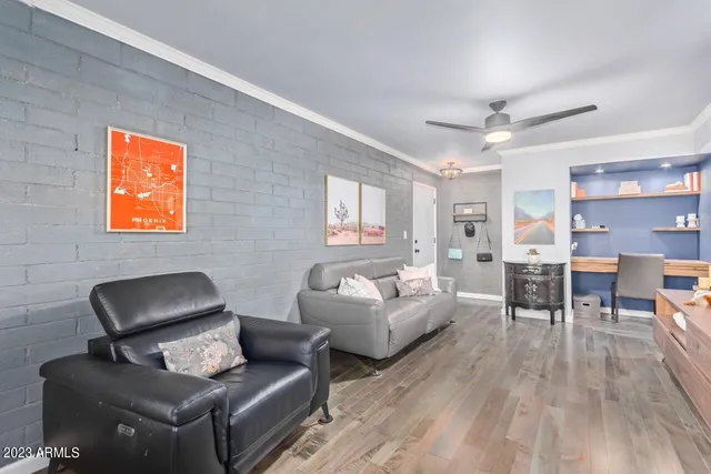a living room with furniture and wooden floor