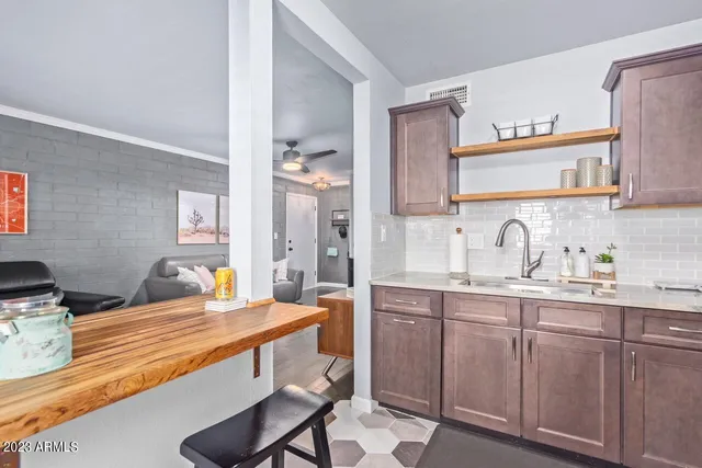 a large kitchen with kitchen island granite countertop a sink and cabinets