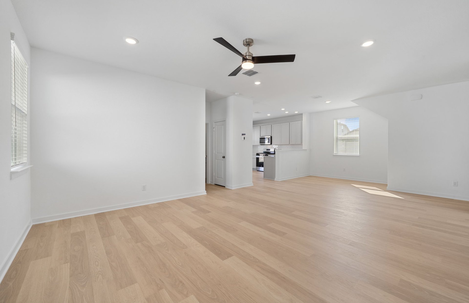 608 Rubber Tree Way Buda, TX 78610 - Photo 8 of 29 a view of empty room with wooden floor and windows