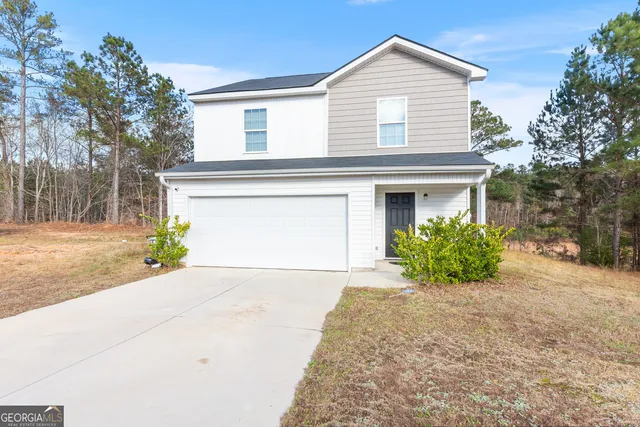 a view of a house with a yard and potted plants