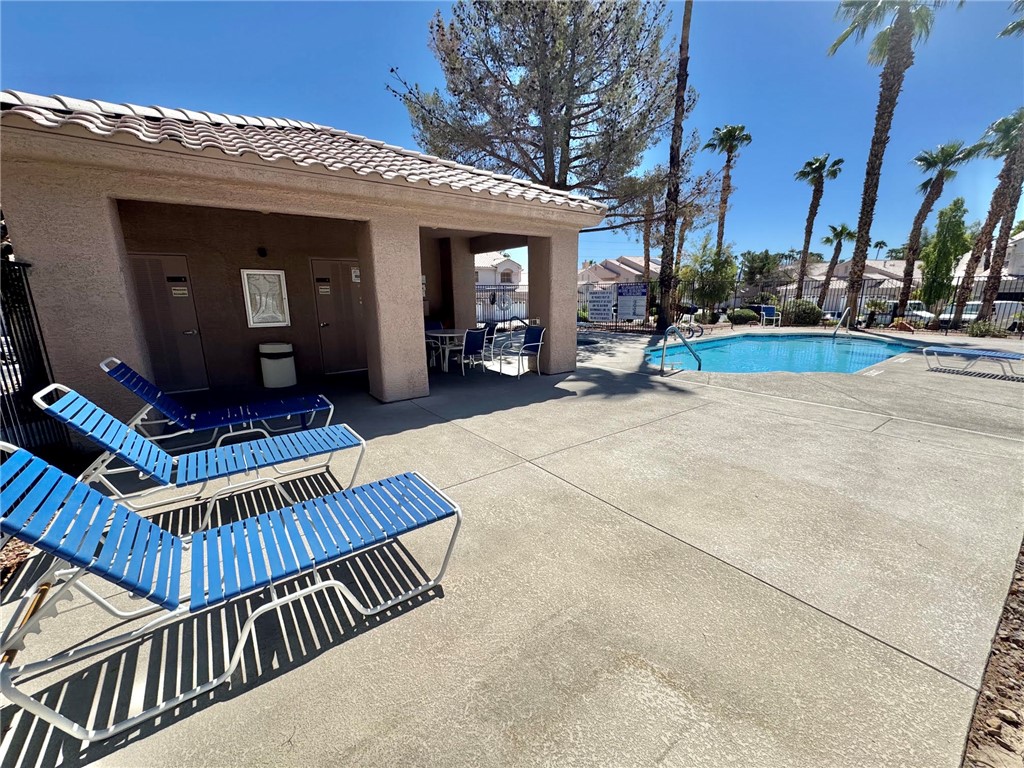 5388 Runningbrook Road Las Vegas, NV 89120 - Photo 24 of 25 A sparkling community swimming pool sits adjacent to a sheltered poolside cabana.