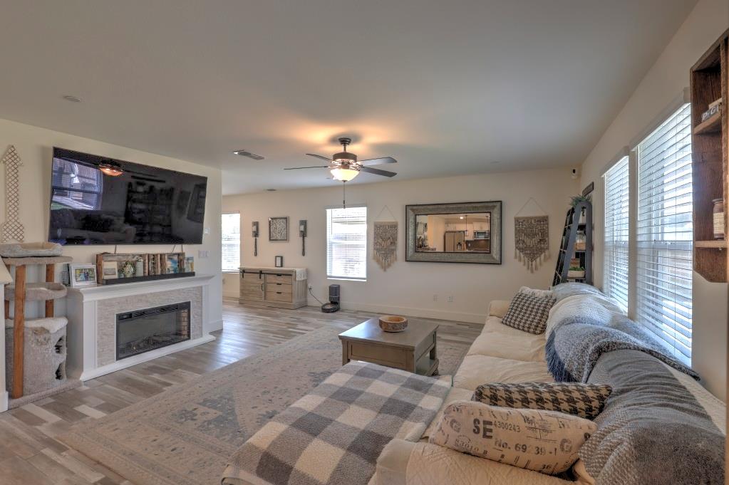 2129 Redding Way Atwater, CA 95301 - Photo 11 of 75 a living room with furniture a fireplace and a flat screen tv