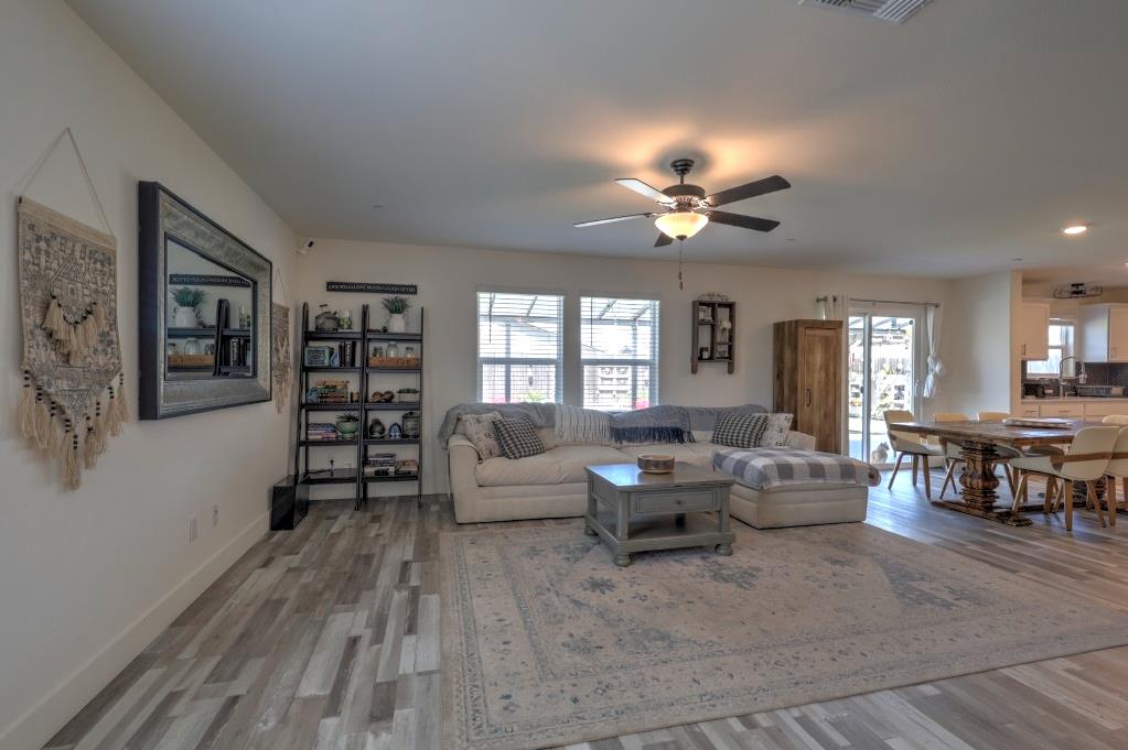 2129 Redding Way Atwater, CA 95301 - Photo 12 of 75 a living room with furniture and a chandelier